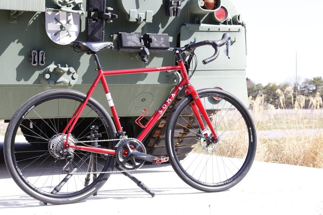 SOMA bike in front of a tank